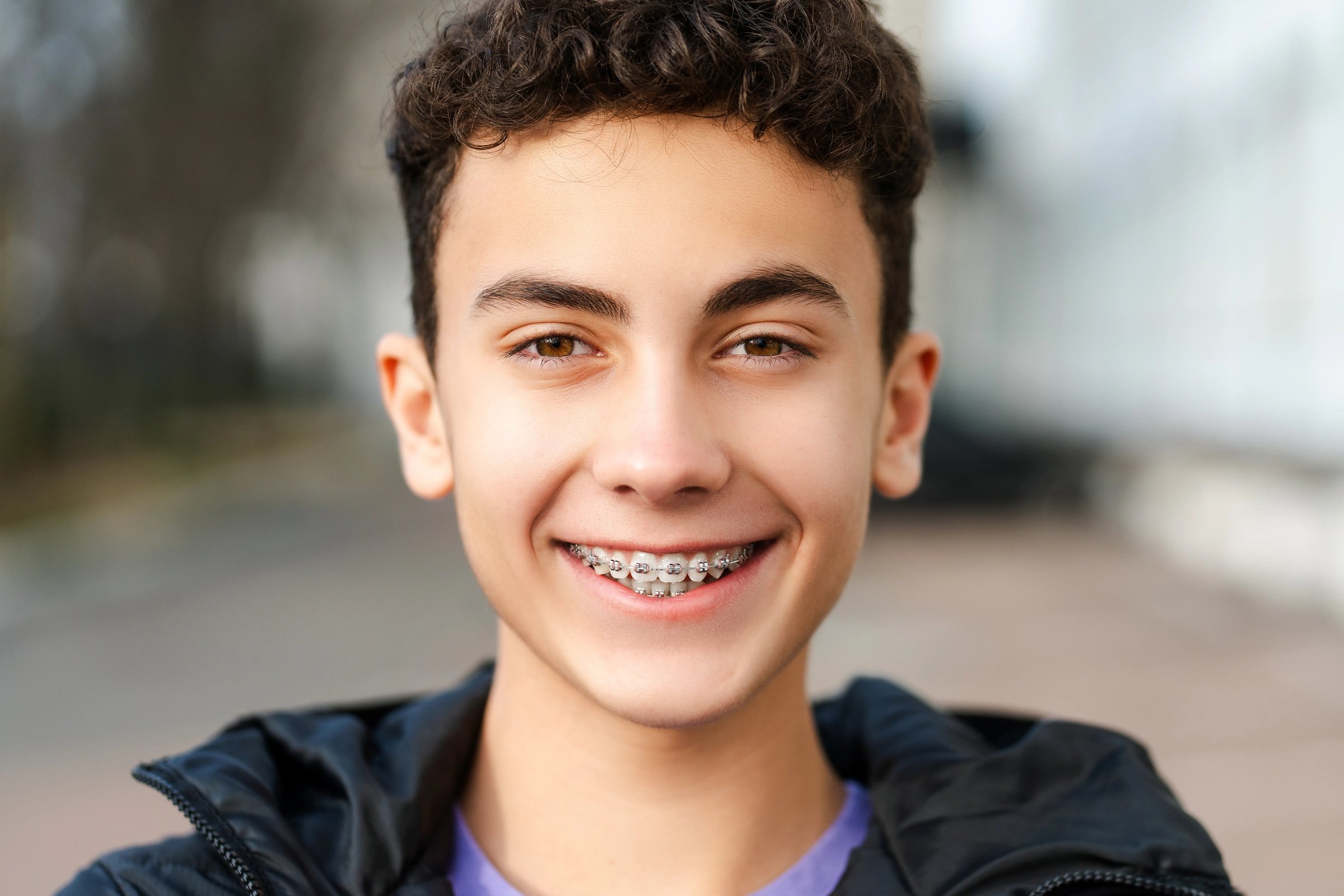 A smiling teenage boy with braces